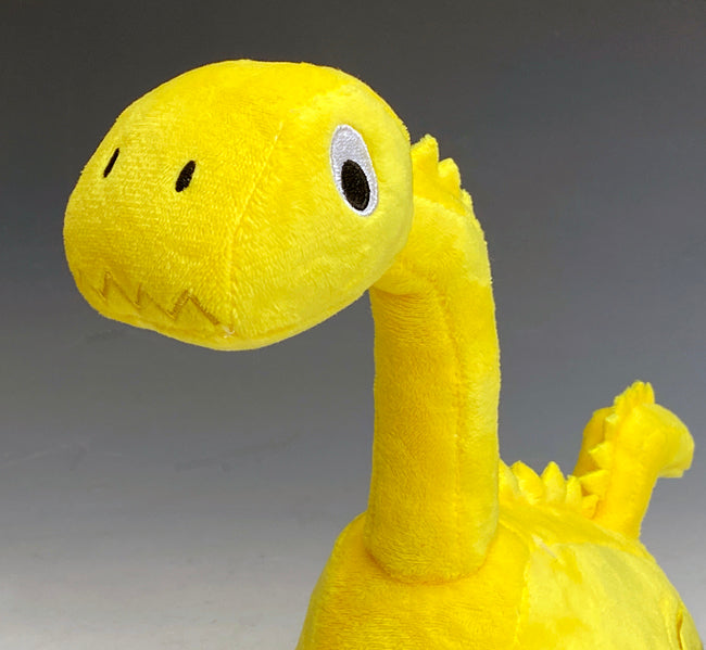 Close-up-view-of-face-of-our-cute-Bronti-dinosaur-plush-stuffed-animal-construction-toy